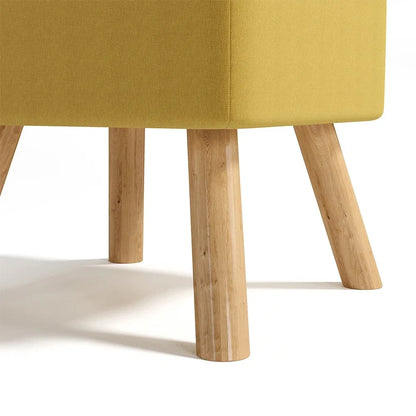 Close-up of a yellow upholstered chair with wooden legs on a white background