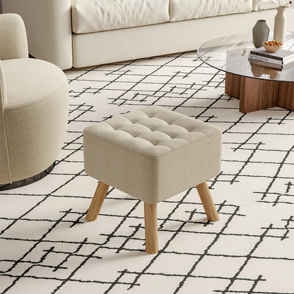 Beige ottoman on a patterned rug in a living room setting