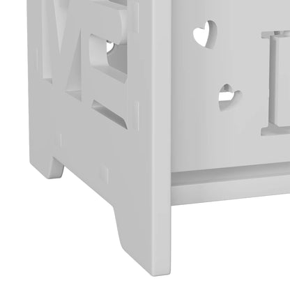 White wooden crib with cut-out heart designs on a white background