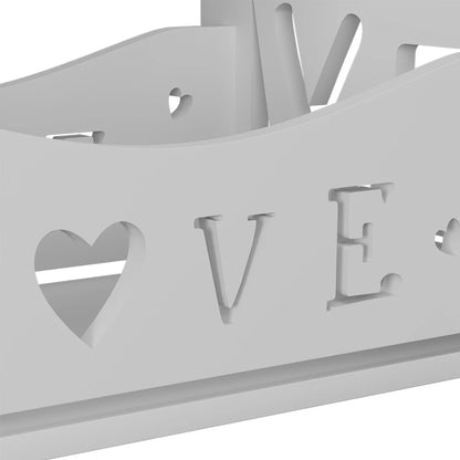 Decorative metal wall art with 'LOVE' and heart shapes cut out on a white background