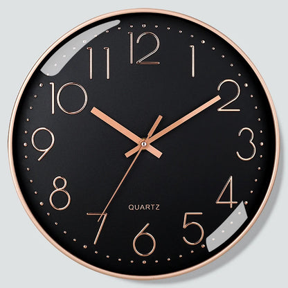Wall clock with black face and rose gold hands on a light gray background