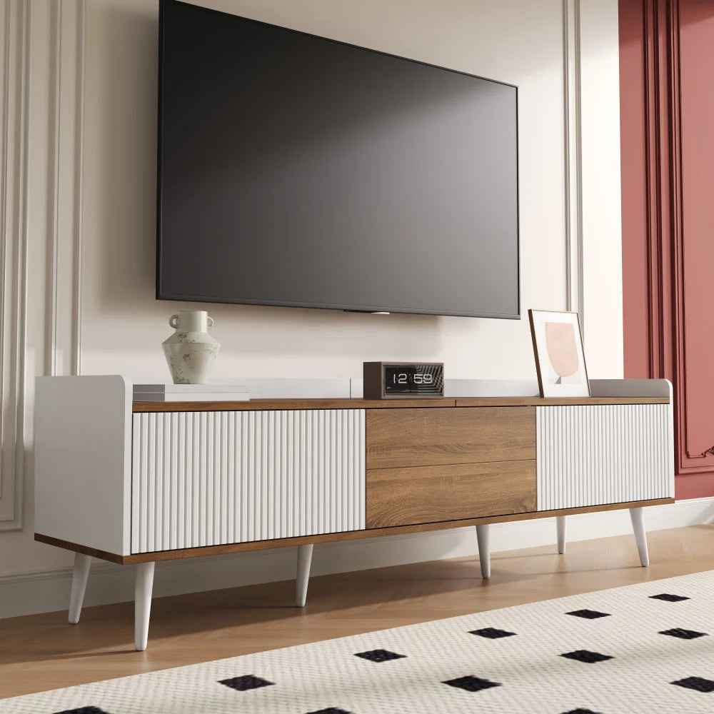 Modern TV stand with a television mounted on the wall in a living room setting.