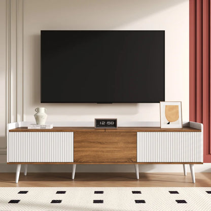 Modern TV stand with a television mounted on a wall in a living room setting.