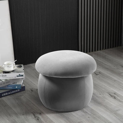 Gray mushroom-shaped stool on a wooden floor with books and a cup in the background.