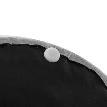 Close-up of a black cushion with a white ball on a white background
