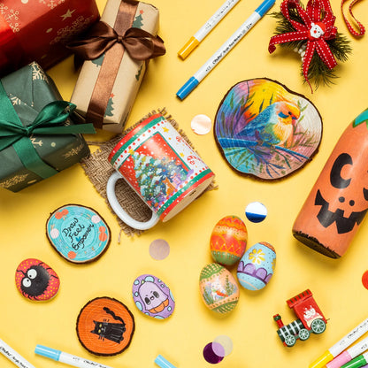 Colorful Christmas-themed items including mugs, coasters, and decorative stones on a yellow background.