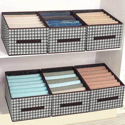 Black and white checkered storage boxes with compartments on a shelf.