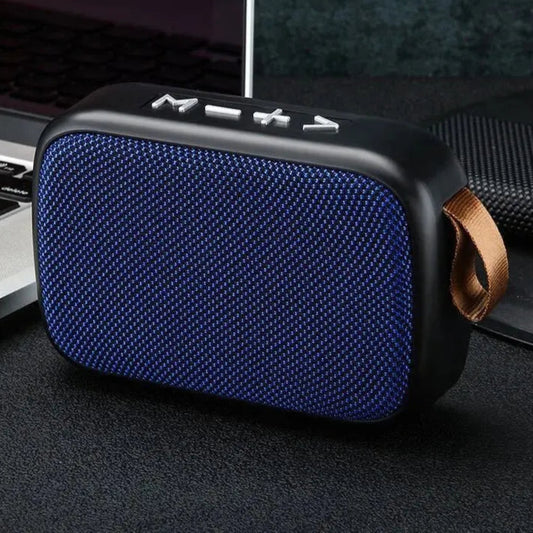 Blue portable speaker with a brown strap on a dark surface