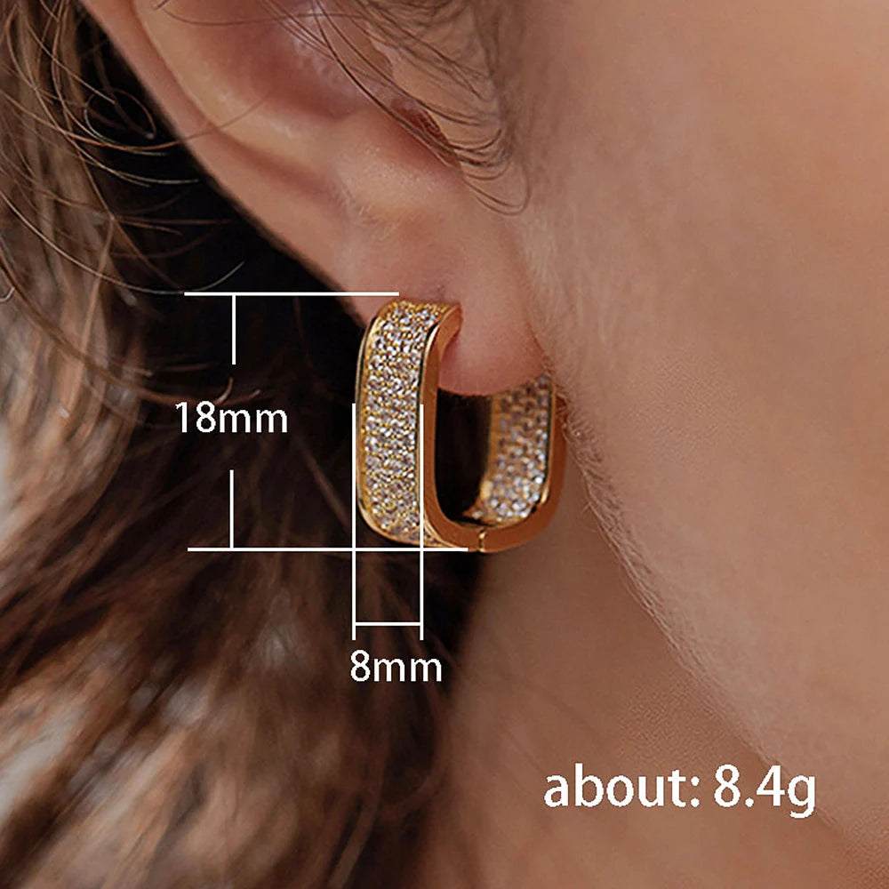 Gold hoop earring worn on an ear with measurements and weight displayed.