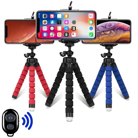Three smartphone tripods in red, black, and blue with a remote control on a white background.