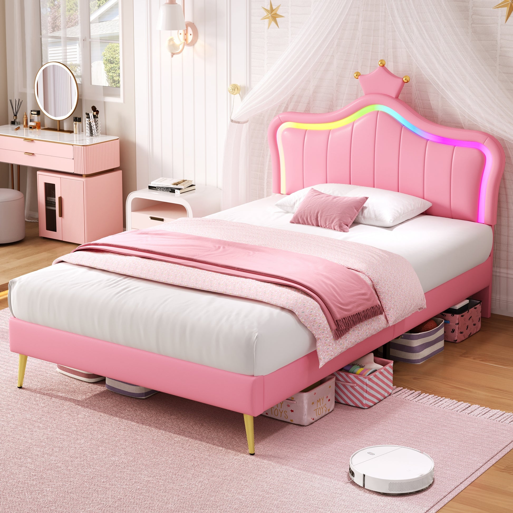 Pink children's bed with rainbow accents in a bedroom setting