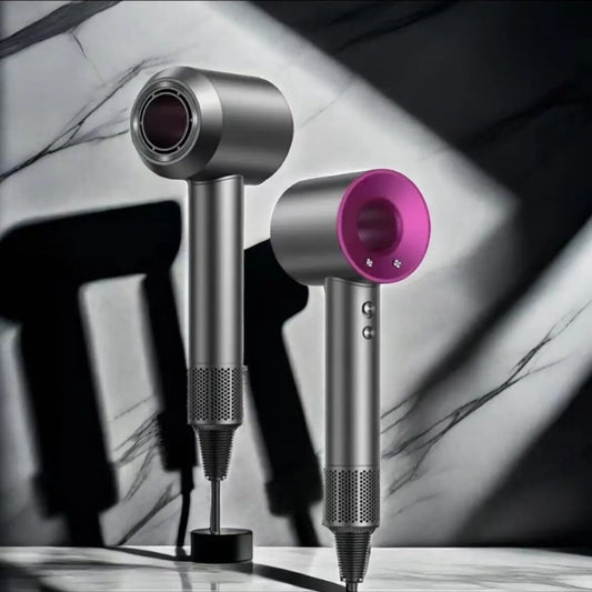 Silver and pink hair dryer on a marble surface with blurred background