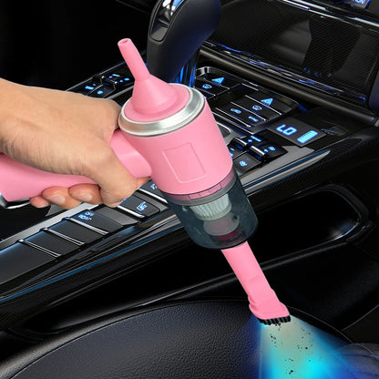 Pink car vacuum cleaner being used inside a car.