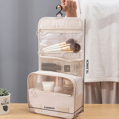 Beige travel makeup organizer with brushes and products on a wooden surface.