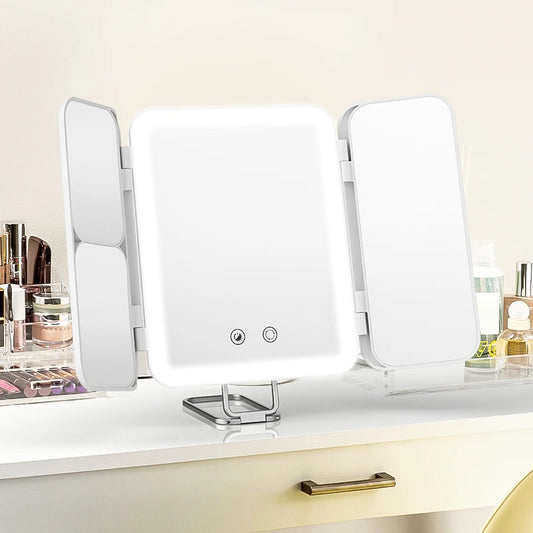 White vanity mirror with three adjustable sides on a light-colored surface.