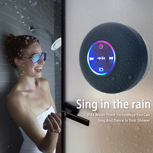 Woman in shower with Bluetooth speaker and text 'Sing in the rain' on a wet surface.