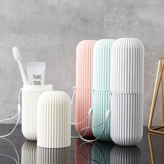Set of three ribbed cylindrical containers in white, pink, and blue on a reflective surface with a gray background.