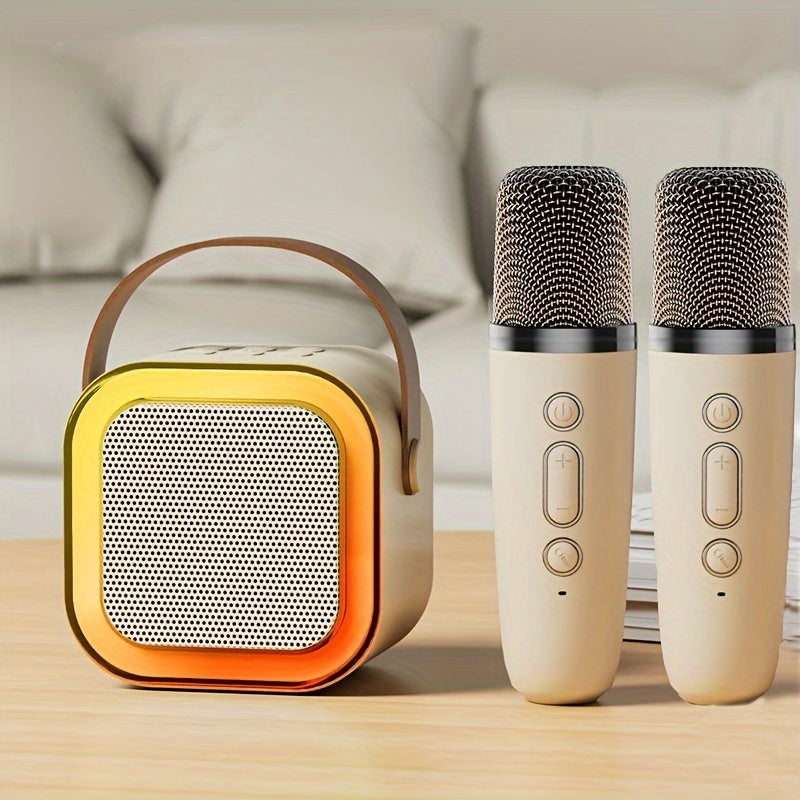 Portable speaker and two microphones on a wooden surface with a blurred sofa in the background