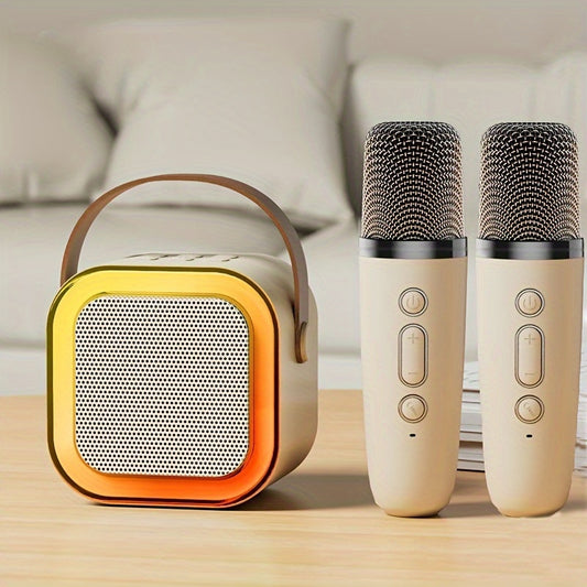 Portable speaker and two microphones on a wooden surface with a blurred sofa in the background