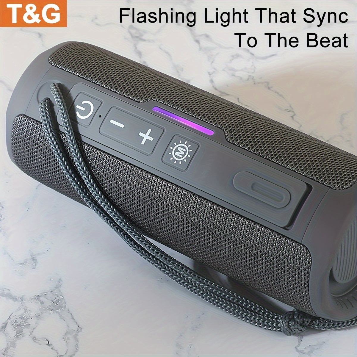 Gray Bluetooth speaker with control buttons on a marble surface, featuring T&G branding.