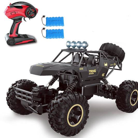 Toy monster truck with remote control and batteries on a white background