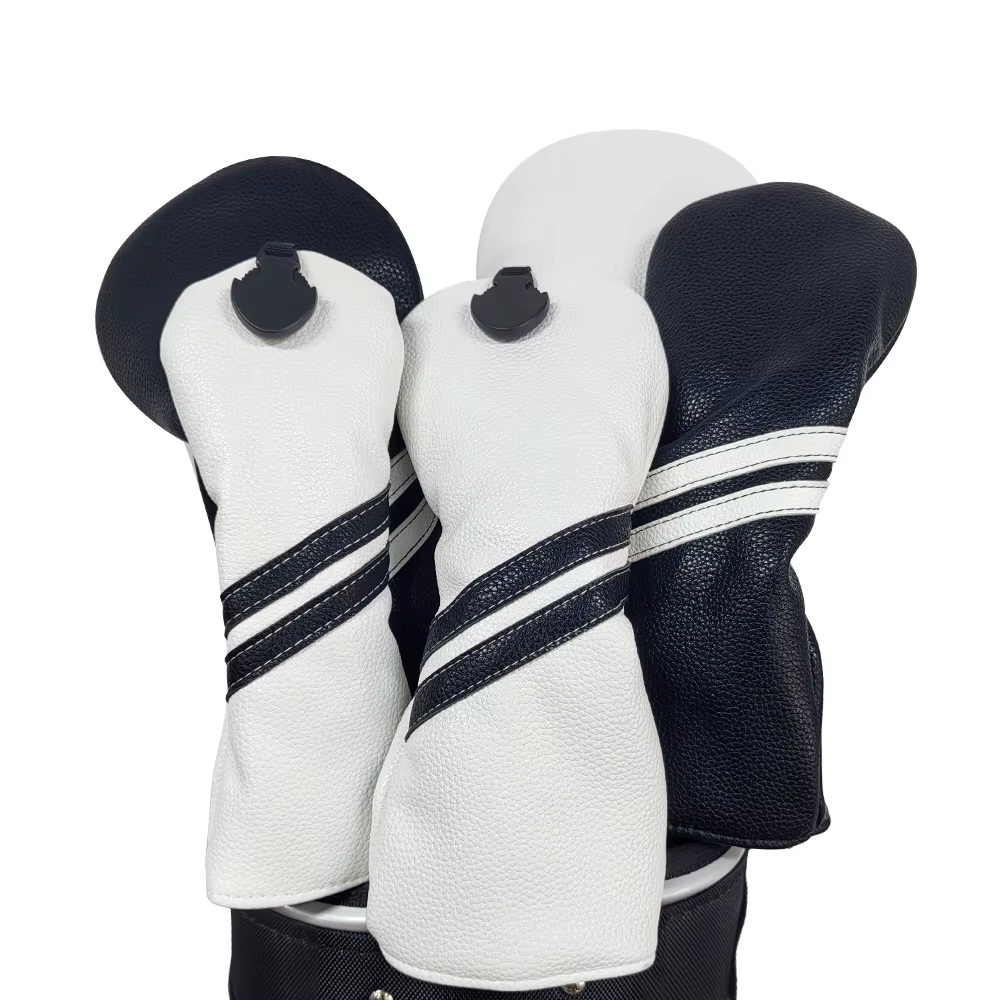 Three golf club head covers in black, white, and navy with striped patterns on a white background.