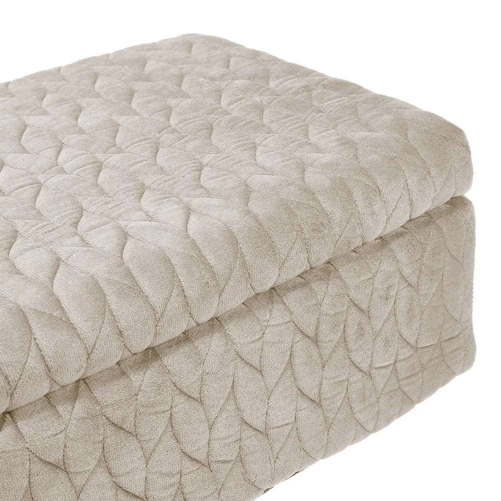 Textured ottoman with a leaf pattern on a white background