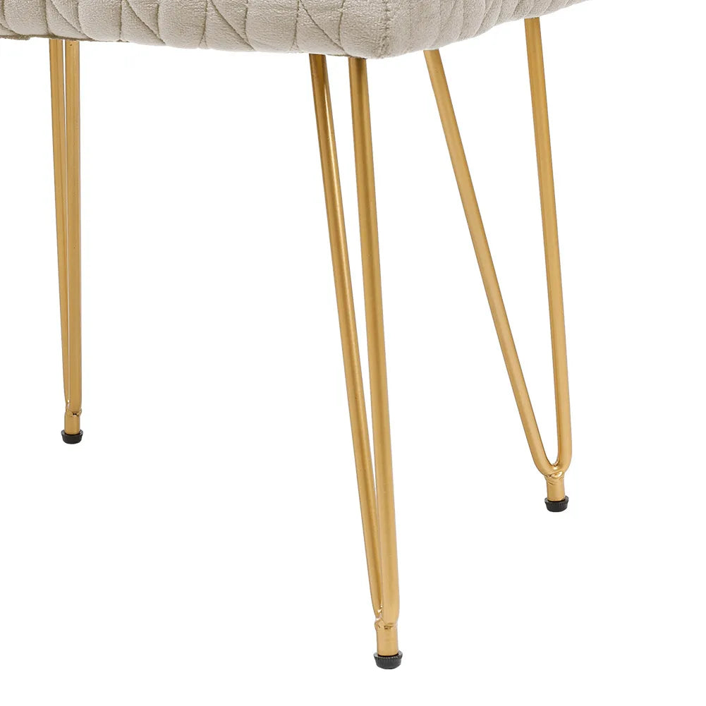 Close-up of a chair with gold metal legs on a white background