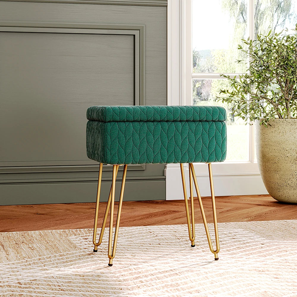 Green quilted stool with gold legs in a room with a window and plant.
