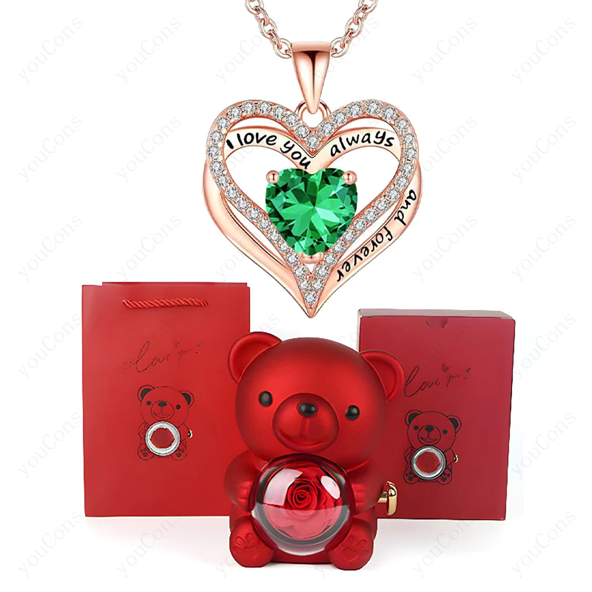 Heart-shaped necklace with green gem and rose, red teddy bear with crystal ball, and red box on white background