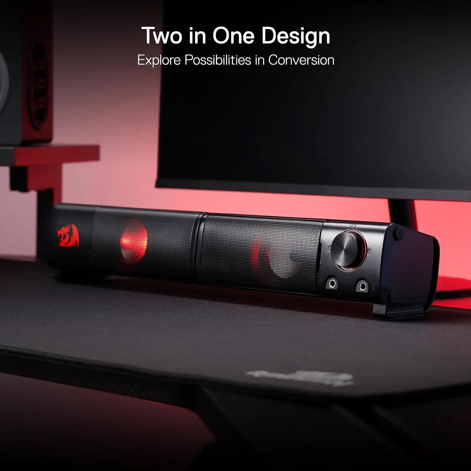 Black electronic device with red accents on a desk, featuring text about a two-in-one design.