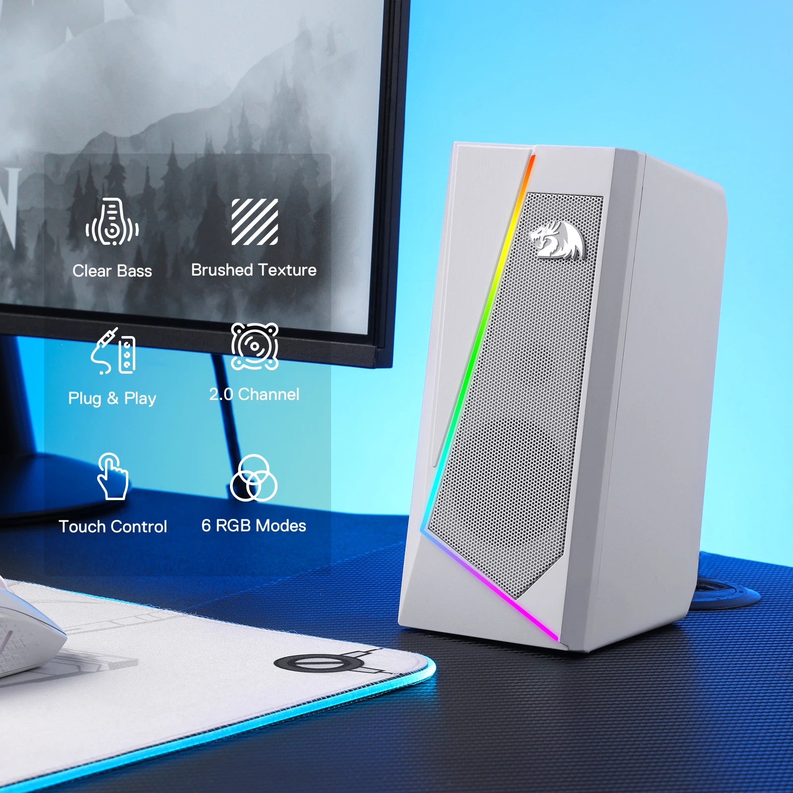 White computer speaker with RGB lighting on a desk next to a monitor