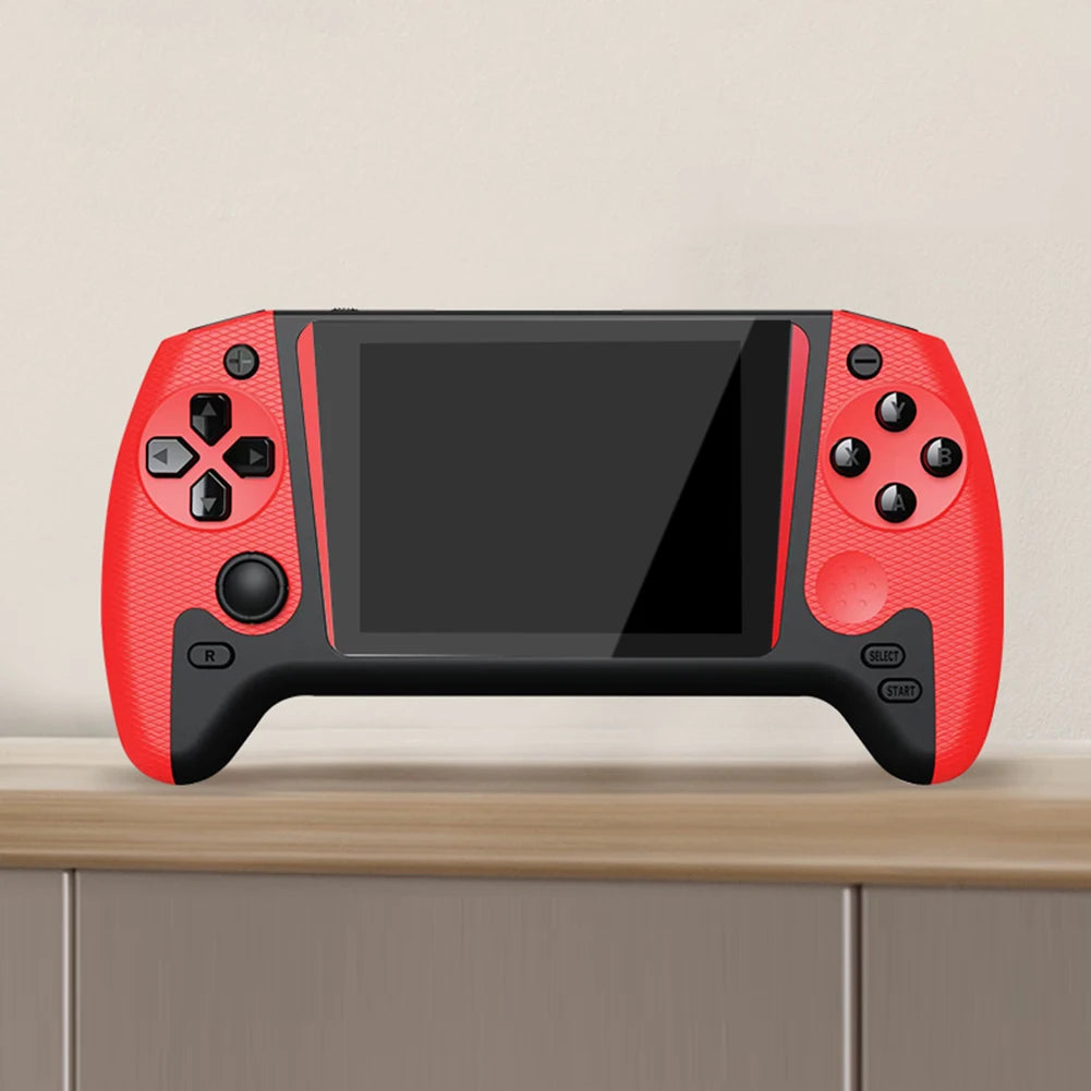 Red handheld gaming console with black screen on a wooden surface