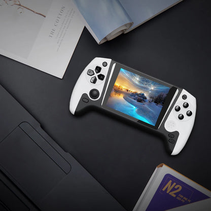 Handheld gaming console with a screen displaying a scenic image on a dark surface.