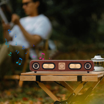 Wooden speaker on a table with a blurred person in the background