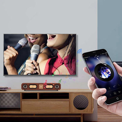 Smartphone controlling a music app displayed on a TV screen with a person holding a microphone.