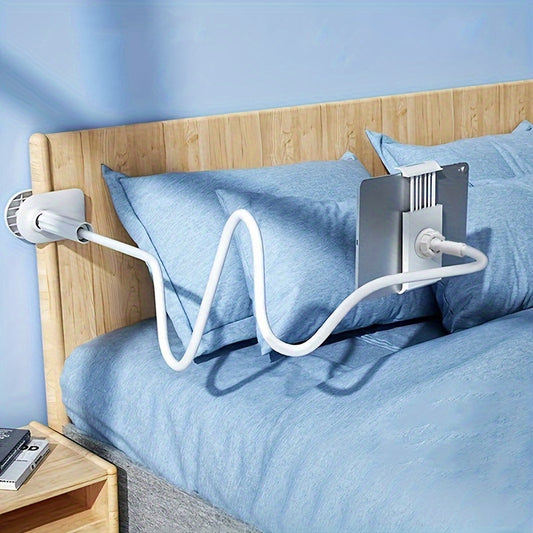 Bedside tablet holder on a bed with blue bedding and wooden headboard