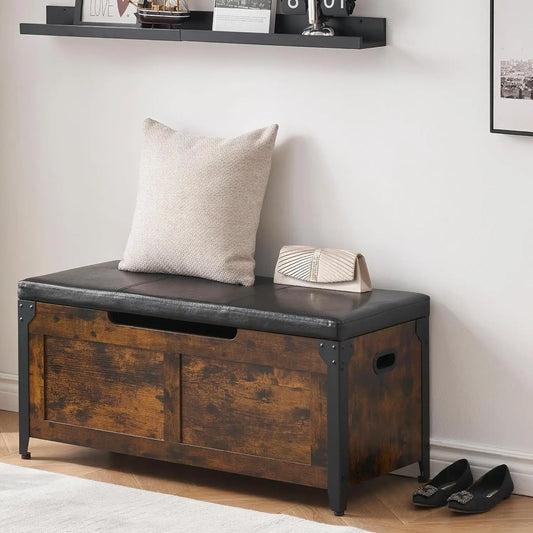 Wooden storage bench with a cushioned seat and a pillow in a room setting.