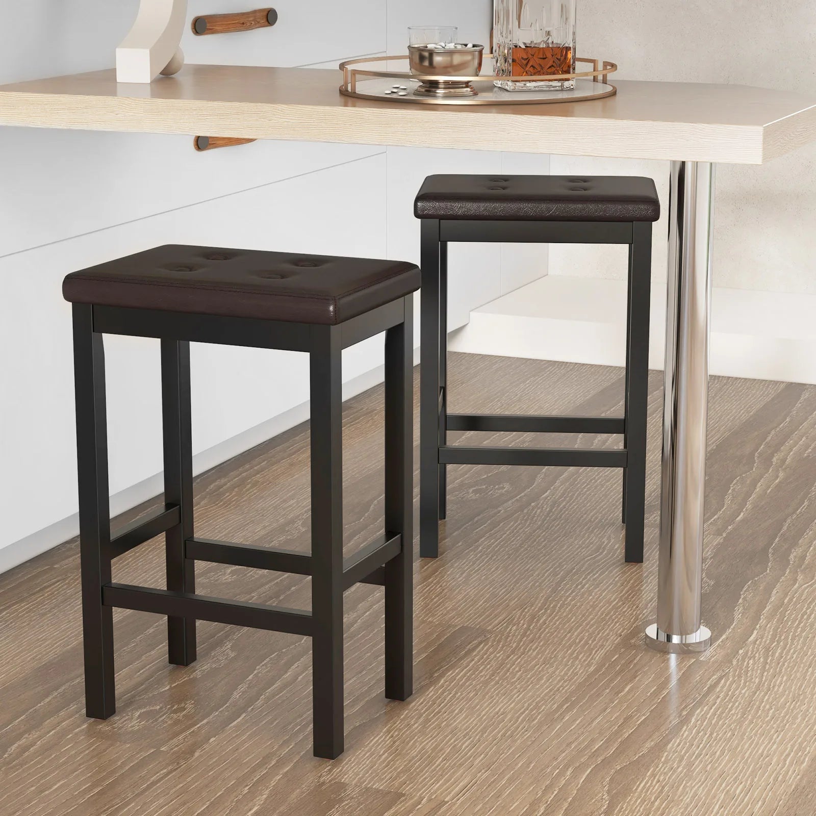 Two brown bar stools in front of a dining table with a white wall background.