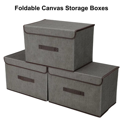 Set of three gray foldable canvas storage boxes with brown handles on a white background.