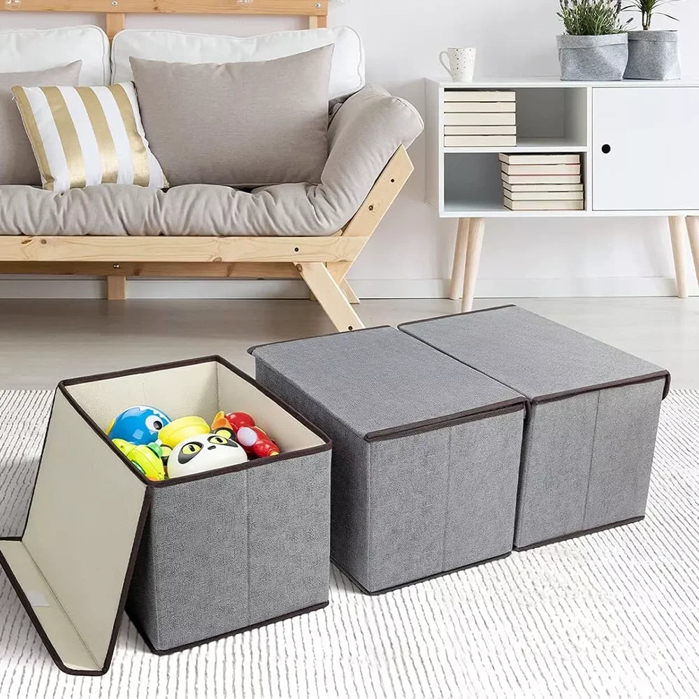 Gray storage cubes with a toy inside, placed on a light-colored floor with a wooden bench and books in the background.