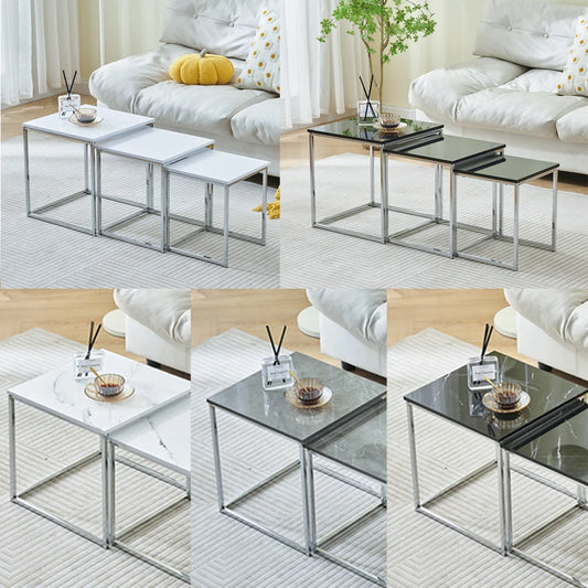 Set of nesting tables in a living room setting with a sofa and decor items.