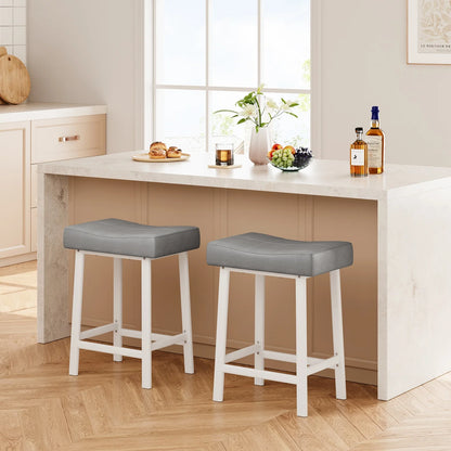 Two gray cushioned stools in front of a kitchen counter with food and drinks.
