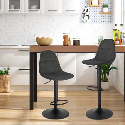 Two black bar stools in a kitchen setting with a wooden counter.
