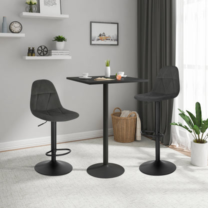 Two black bar stools in front of a small black table in a room with gray walls and white curtains.