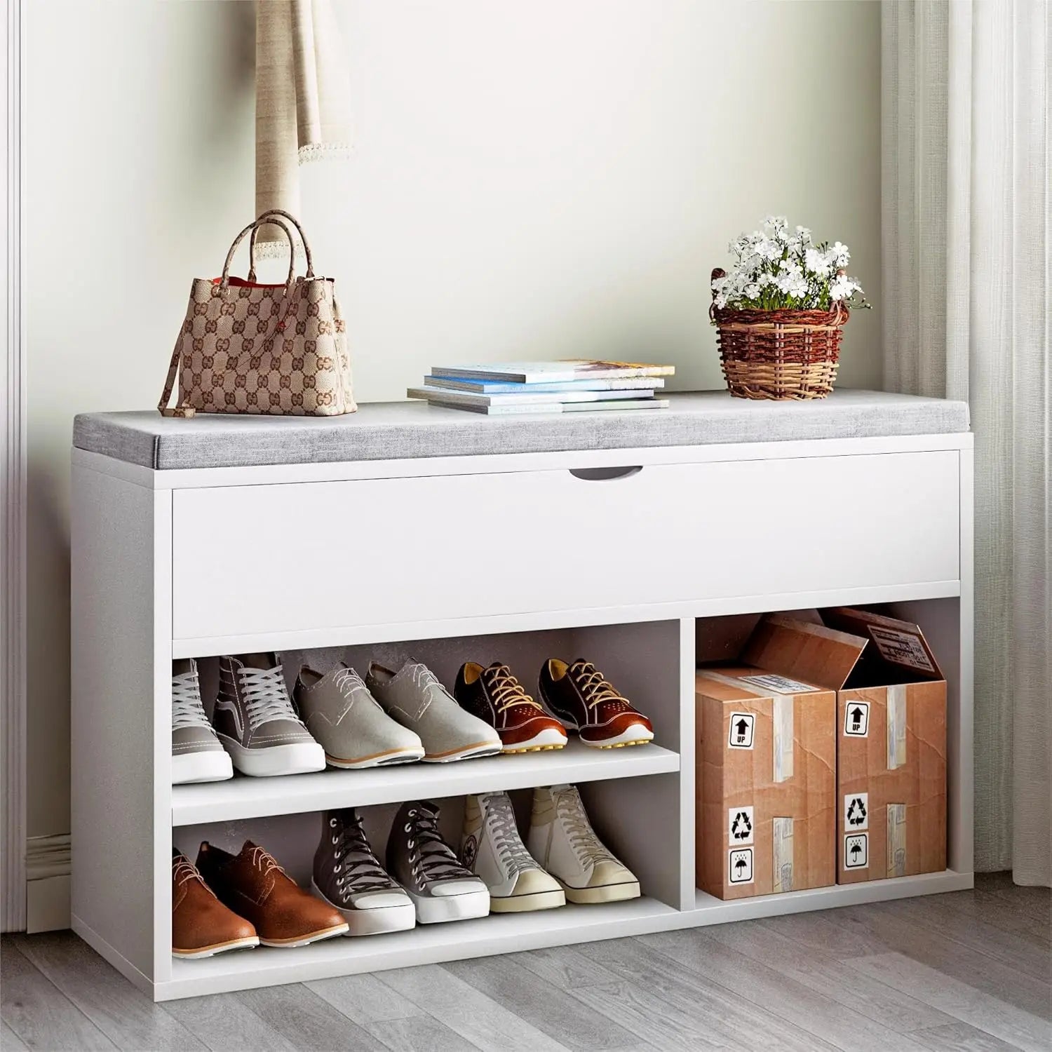 White shoe storage bench with shoes, a handbag, and a plant on top in a room.