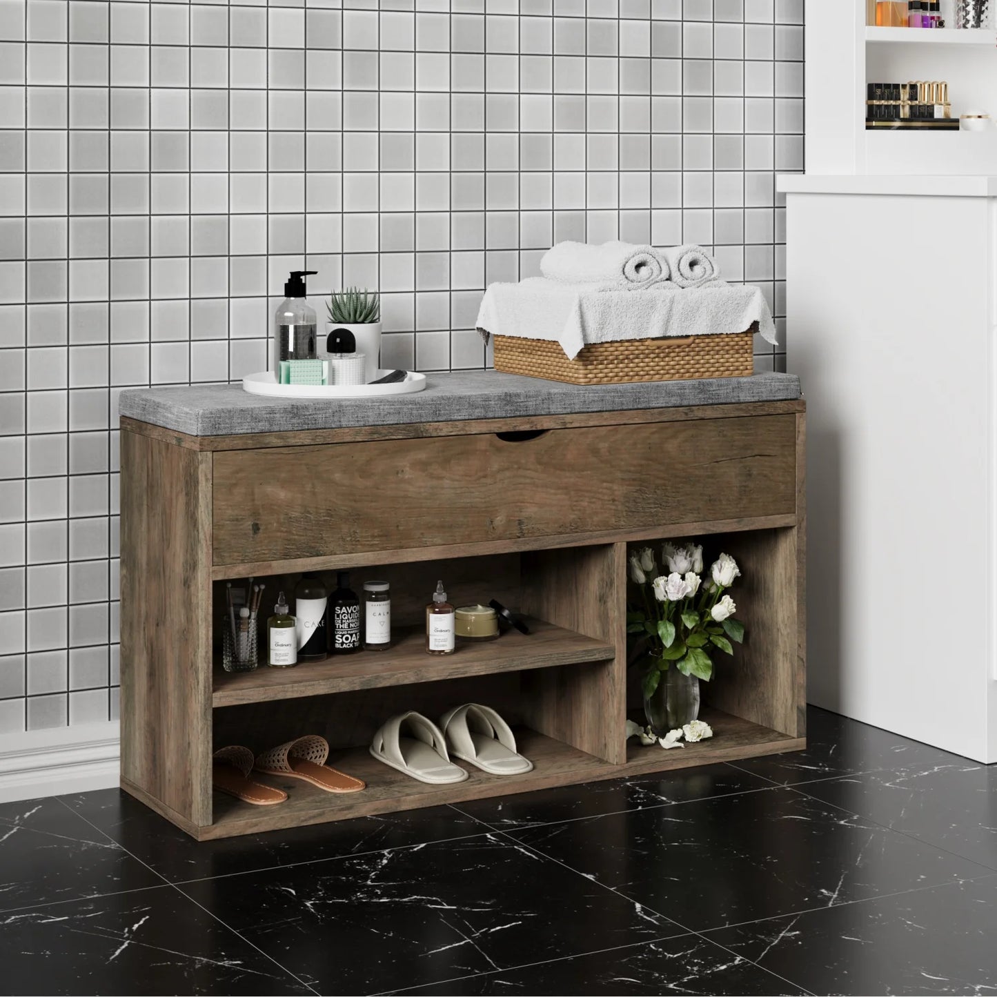 Bathroom vanity with storage shelves, sink, and various items against a tiled wall.