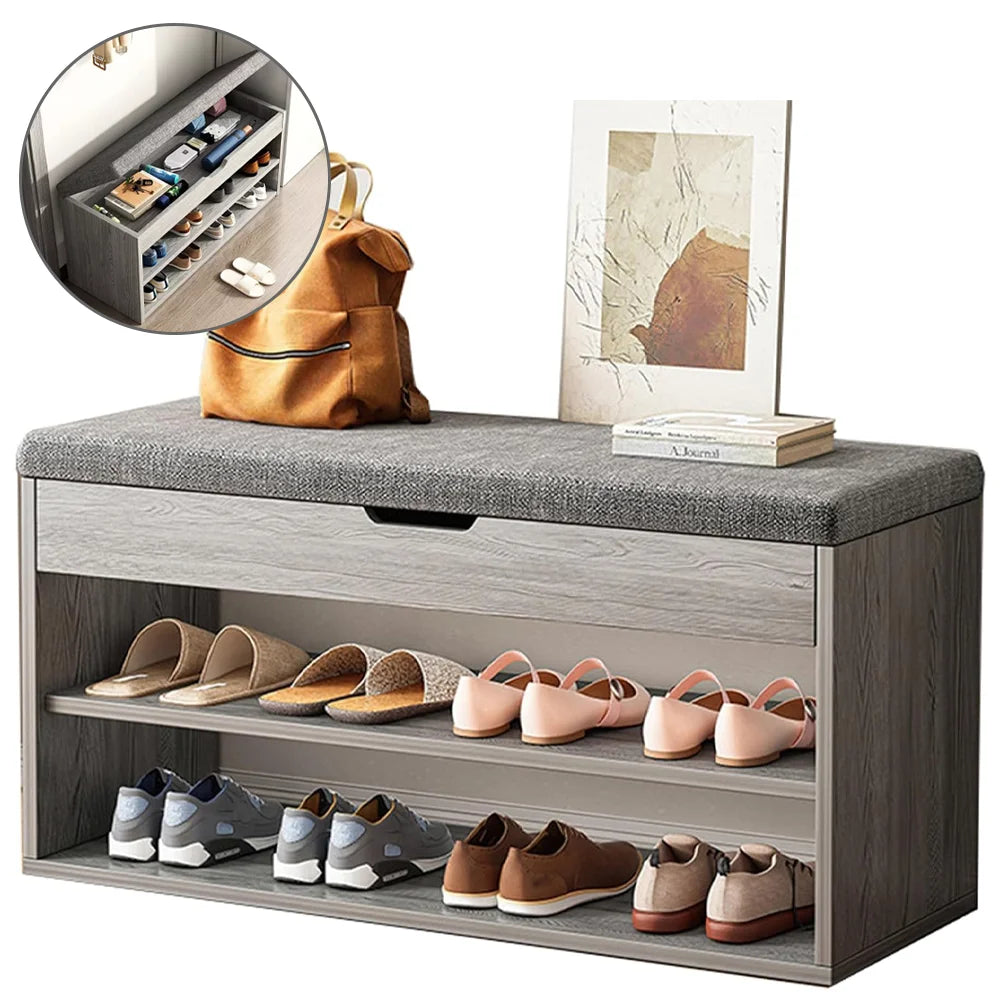 Gray shoe bench with storage compartment filled with shoes, a backpack, and books on a white background.