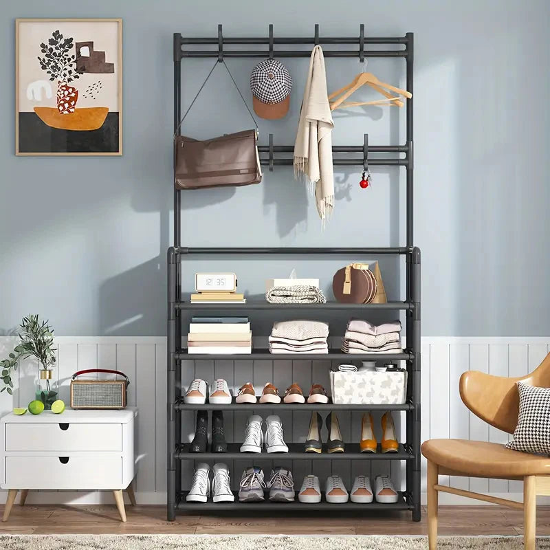 Multifunctional metal rack with shelves and hooks against a light blue wall.