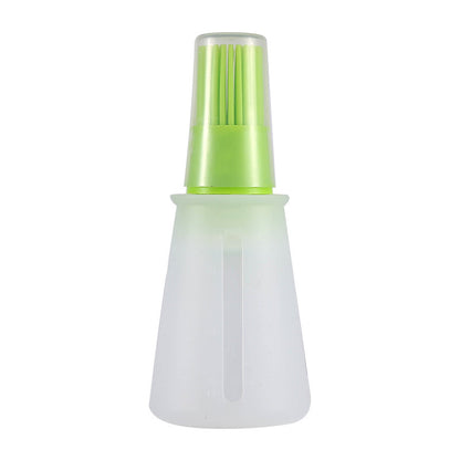 Green and white spray bottle on a white background